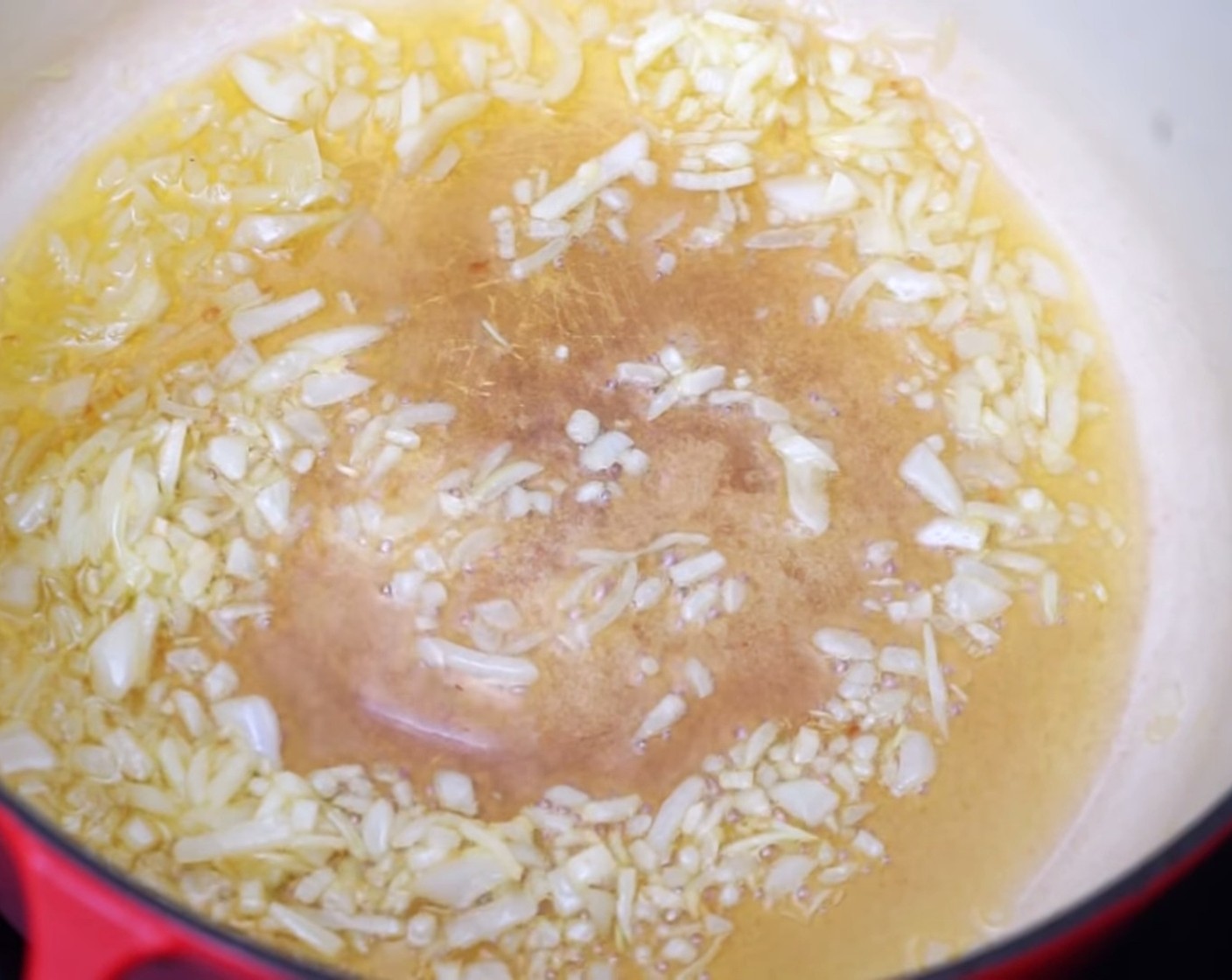step 2 Place a large pot on the stove at medium heat and add Extra-Virgin Olive Oil (4 Tbsp). Once this has started to warm up, add the finely diced onion and simmer for 6-7 minutes or until they have started to turn a golden brown.