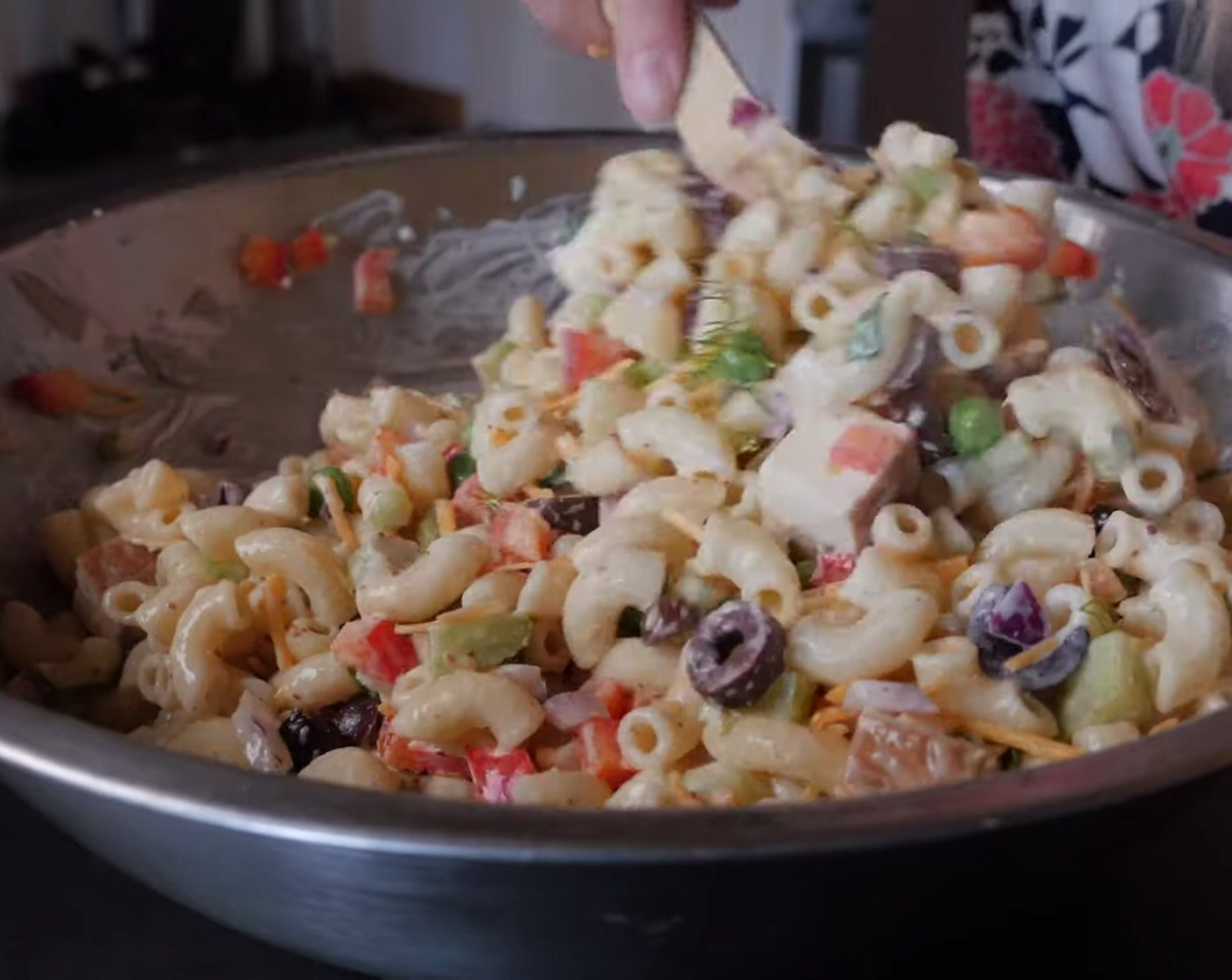 step 3 Stir in the cooked pasta, Frozen Green Peas (4 Tbsp), Red Bell Pepper (1/2), Kalamata Olives (4 Tbsp), Red Onions (4 Tbsp), Celery (1 stalk), Vegan Cheddar Cheese (1/3 cup), Smoked Tofu (1/2 block), and season with Sea Salt (to taste) and Ground Black Pepper (to taste).