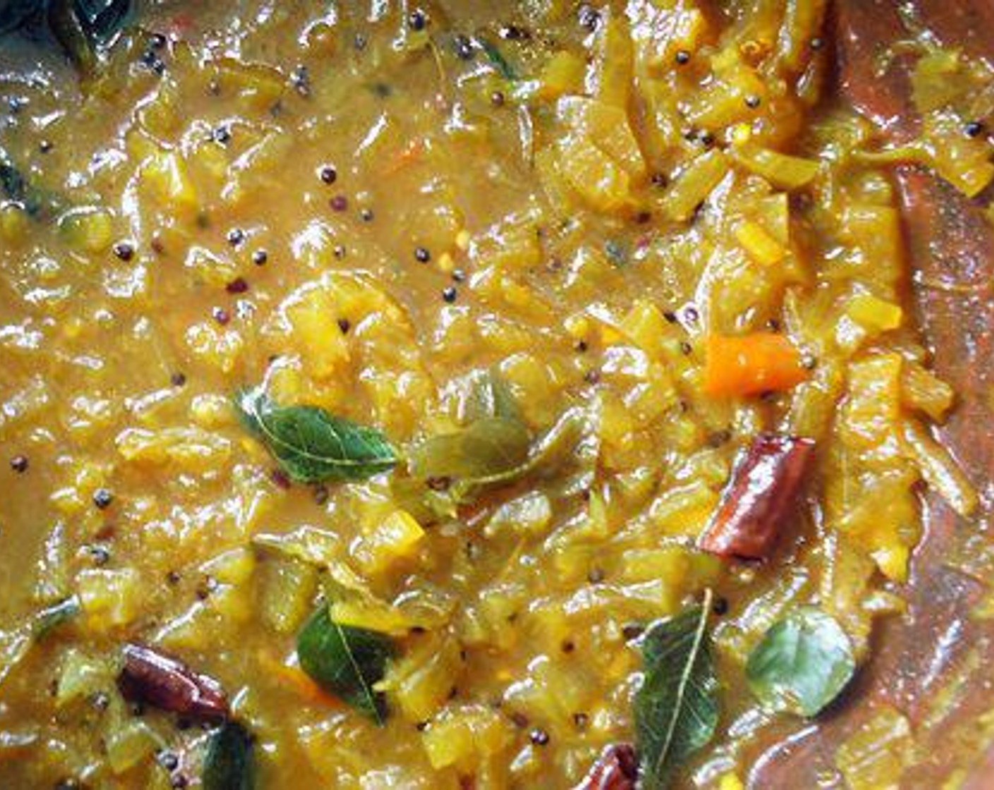 step 3 To this add Fenugreek Seeds (1 tsp). To a pan add Oil (2 Tbsp), add Mustard Seeds (1/2 tsp) and once it pops add Dried Red Chili Peppers (2) and saute till the color of the red chilies turn to light brown. Pour this on top of the curry and serve with Curry Leaves (to taste).