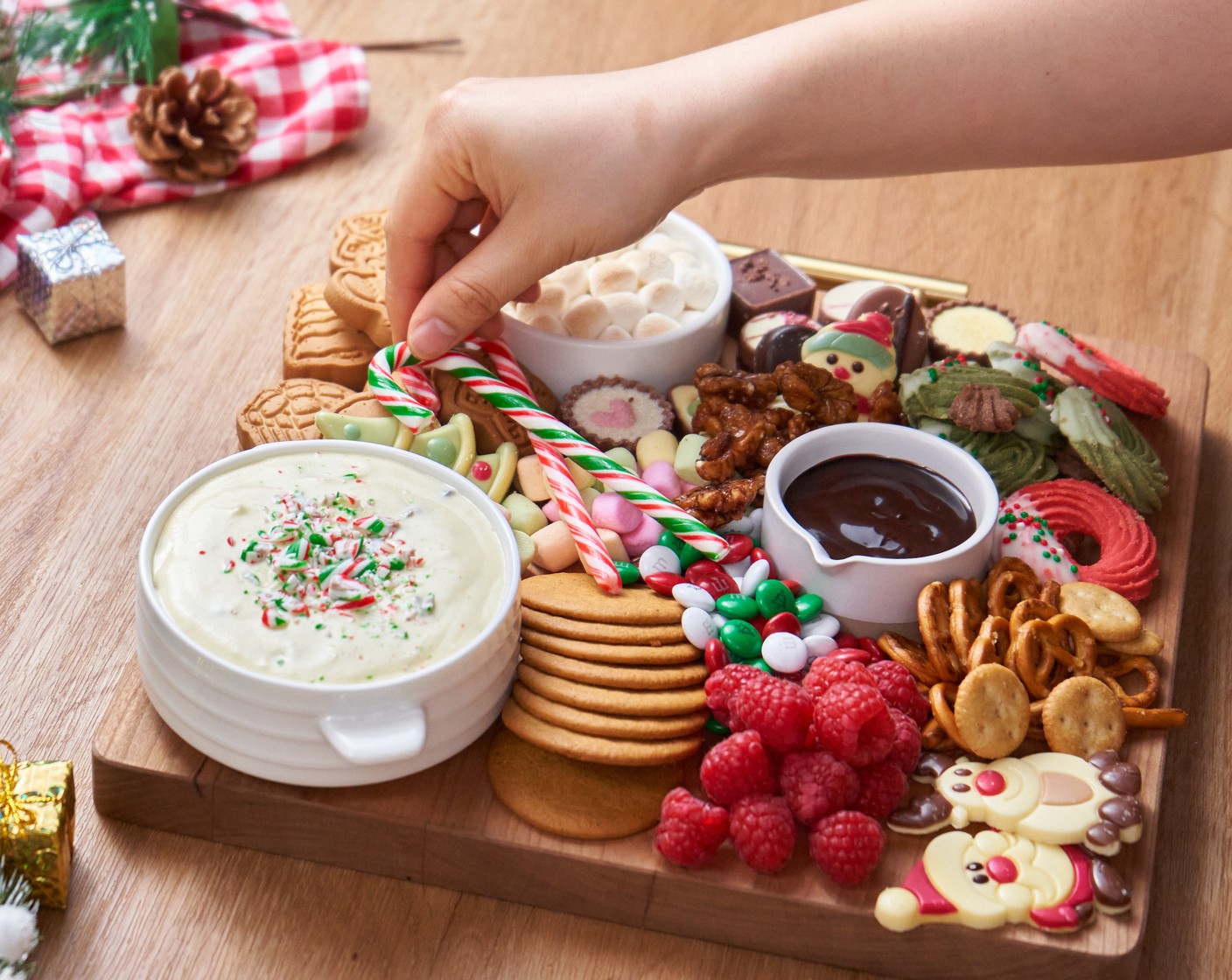 step 4 Arrange the White Chocolate (1/3 cup), Milk Chocolate (1/3 cup), Mini Colored Marshmallows (1/2 cup), M&M's® Milk Chocolate Candy Holiday Colors (1/4 cup), Candied Walnuts (4 Tbsp), Fresh Raspberry (1/2 cup), Fresh Strawberry (1/2 cup), and Candy Canes (4) on the board to fill up the empty spaces, enjoy with family and friends!