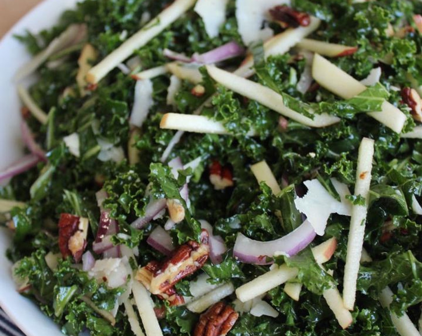 step 7 When ready to serve, add the pecans, onions, and Fuji Apple (1) to the kale and toss well to combine. Add the Shaved Parmesan Cheese (1 cup), toss gently, and serve.