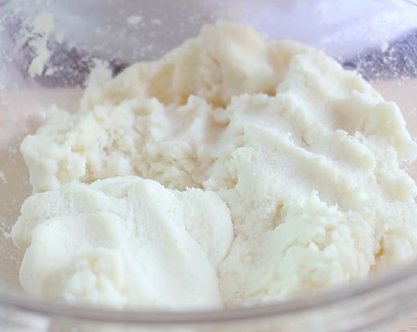 step 2 Next slowly add the Harina P.a.n.® White Corn Meal (2 cups) while whisking using a spoon. Using your hands, mix and break apart any lumps. If the mixture is too watery add more Harina Flour. However, we need the mixture to be a bit wet so that it is not too crumbly when making the arepas. Let the mixture rest for 5 minutes.