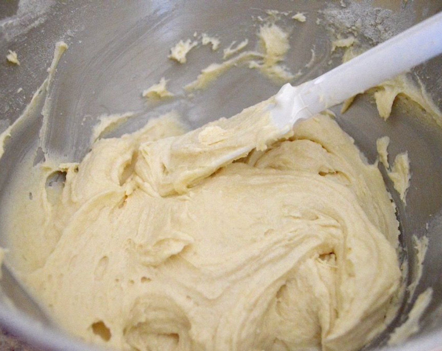 step 3 Then, set up a stand mixer with a paddle attachment and beat the Butter (1 cup) and Granulated Sugar (1 cup) together in its bowl. Add the Eggs (4) one at a time, pushing down the sides as you add them in. Finally, add 1/3 of the dry ingredients followed by the Milk (4 Tbsp). Repeat this again, and then end with the final 1/3 of the dry ingredients.
