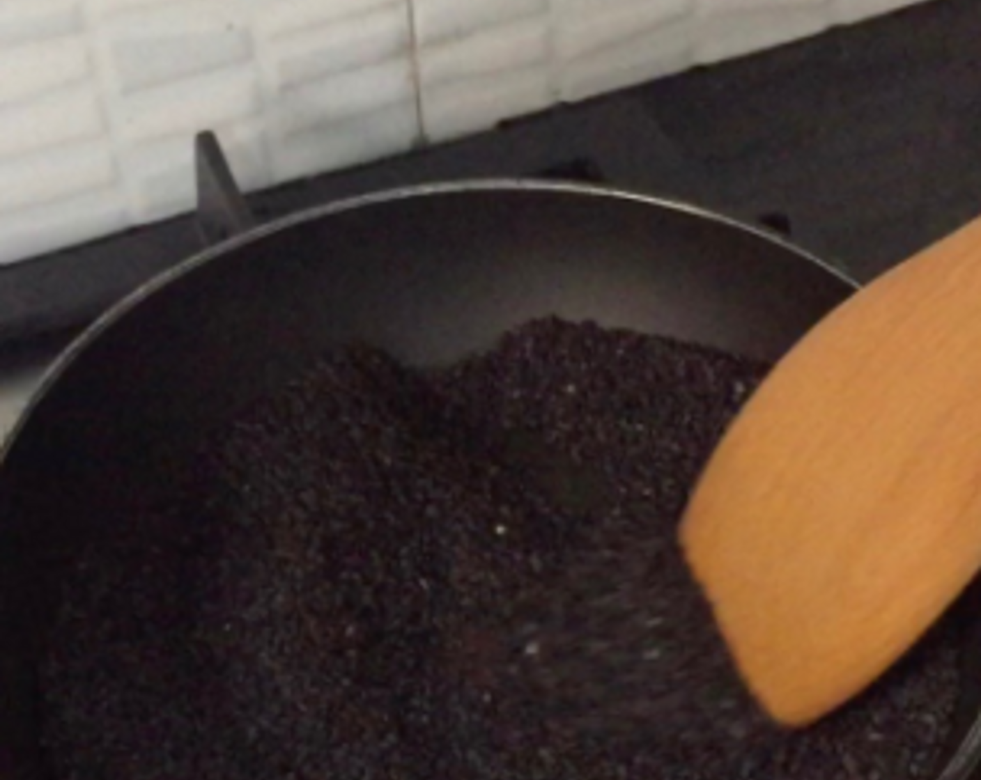 step 9 While waiting for the ginger soup to simmer, prepare the glutinous rice ball filling. Lightly toast Black Sesame Seeds (4 Tbsp) over medium heat for 2 to 3 minutes till aromatic.