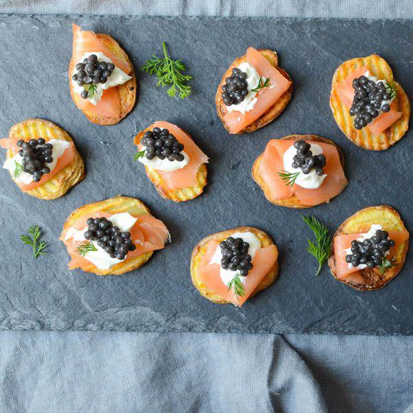 Smoked salmon and caviar on crispy potatoes appetizer