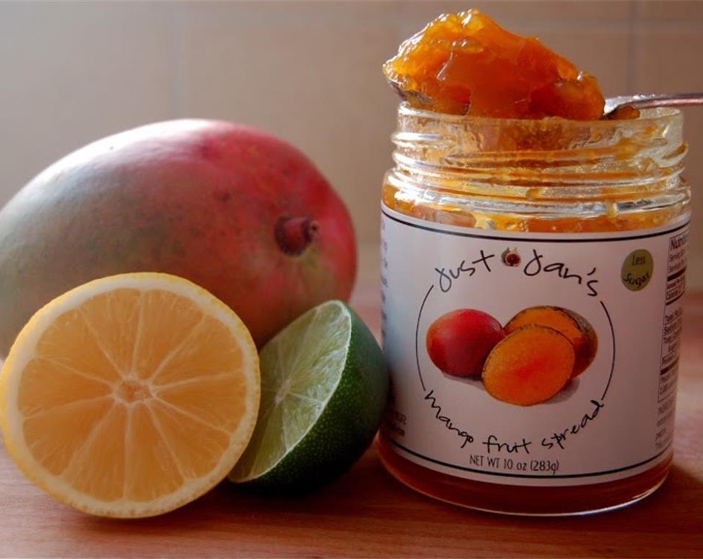 step 1 In a cocktail shaker add Vodka (1.5 fl oz), Just Jan's® Mango Spread (1 Tbsp), juice of a Lime (1), Simple Syrup (1 fl oz) and shake well. Pour over a tall glass full of Ice (to taste).