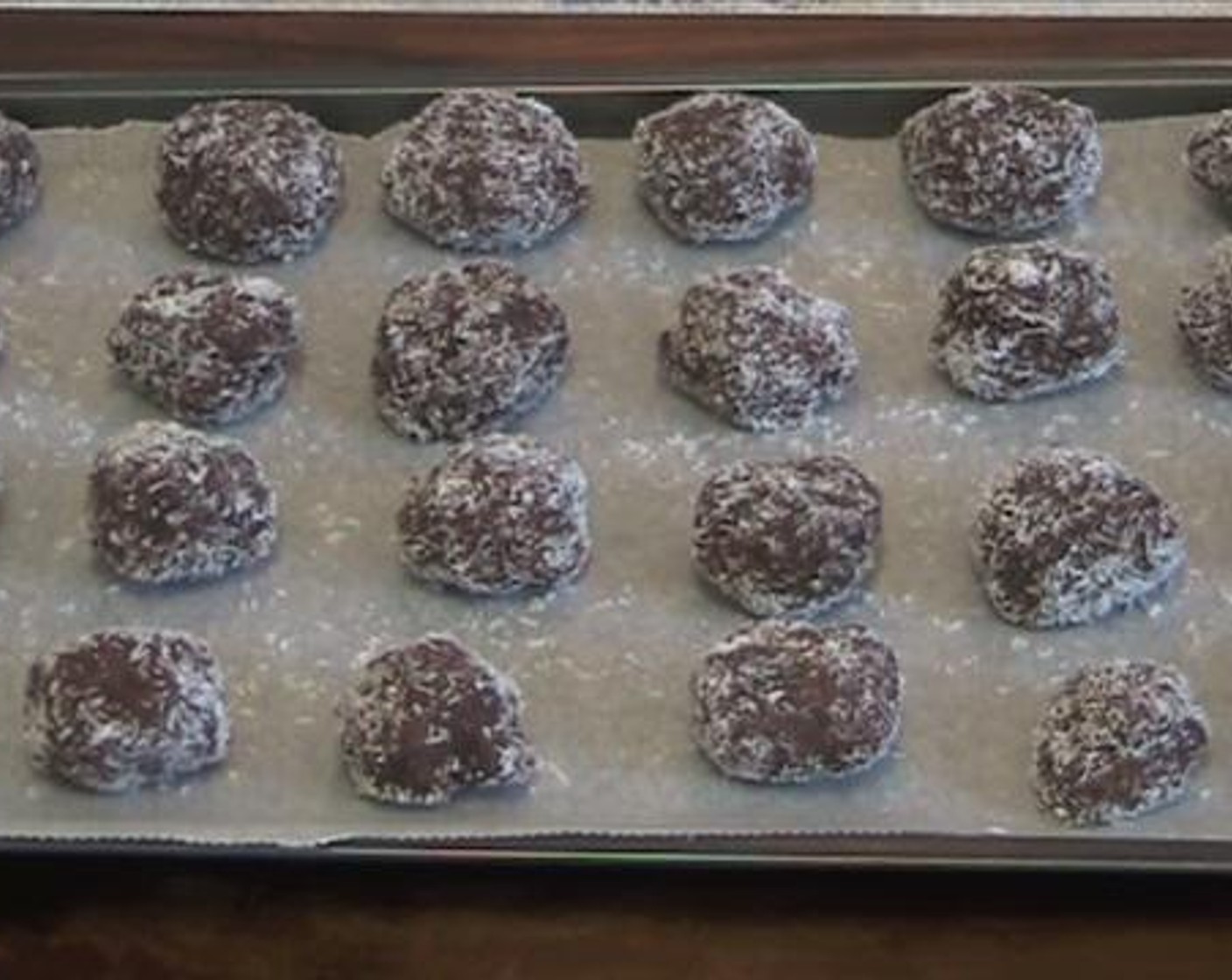 step 3 Take teaspoons of the mixture, shape them into small balls and roll them over some  Desiccated Coconut. Place the balls on a baking tray and bake under 180 degrees C (350 degrees F) for about 15 minutes.
