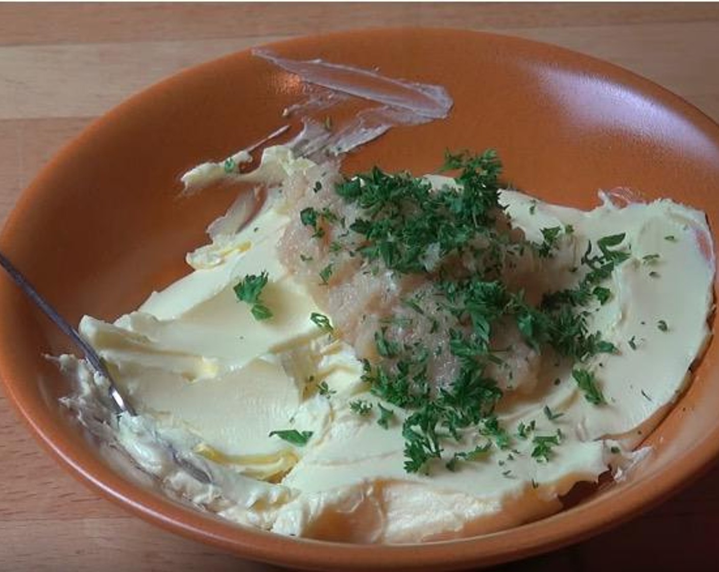 step 2 In a large mixing bowl, add Butter (4.5 oz), Garlic (1 clove) and Fresh Parsley (to taste). Gently mix until combined.