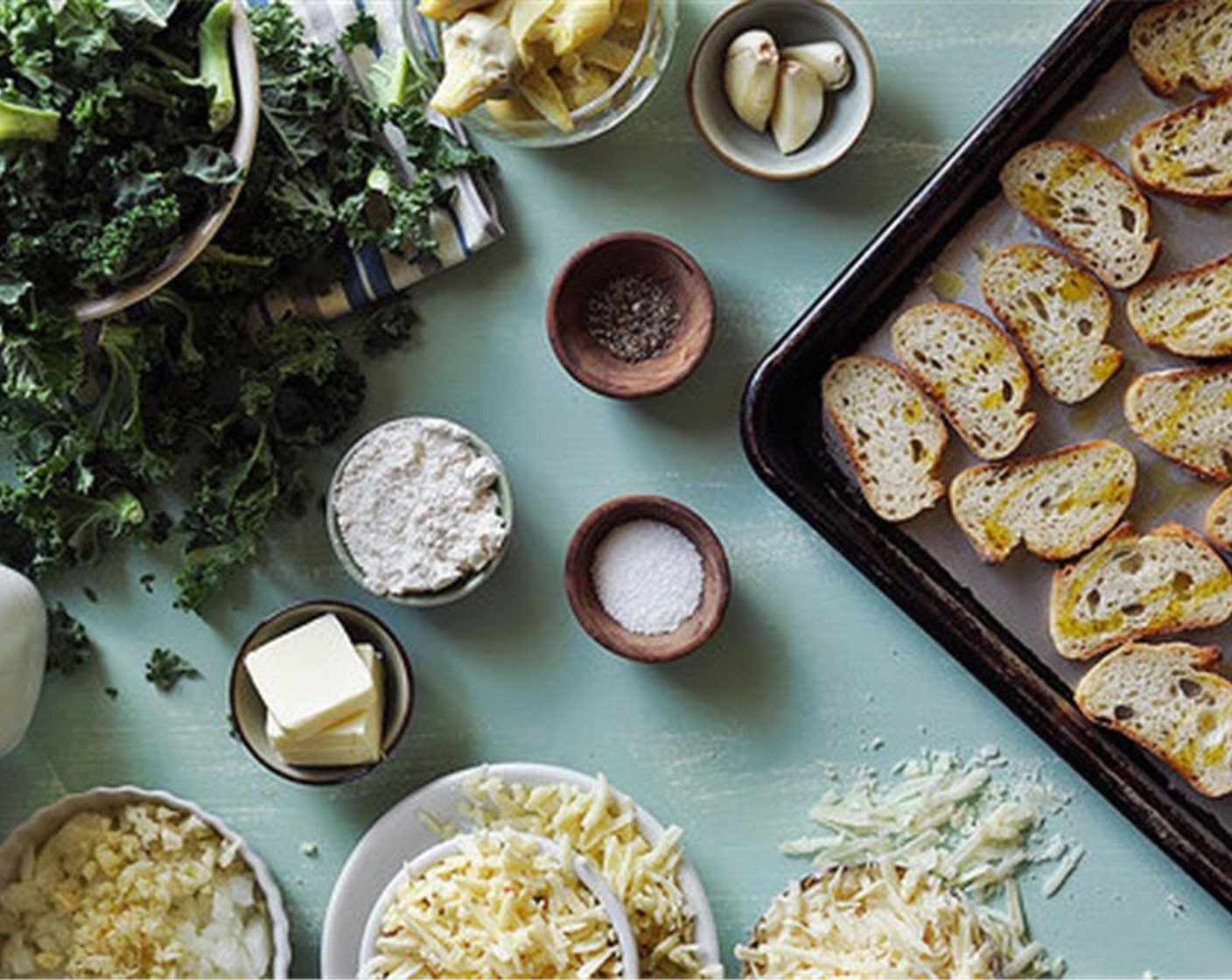 step 2 Arrange the Baguette (1) on a baking sheet, in a single layer. Drizzle with Olive Oil (2 Tbsp) and bake for about 15 to 20 minutes, or until golden brown and crispy. Flip the bread over, halfway through baking.