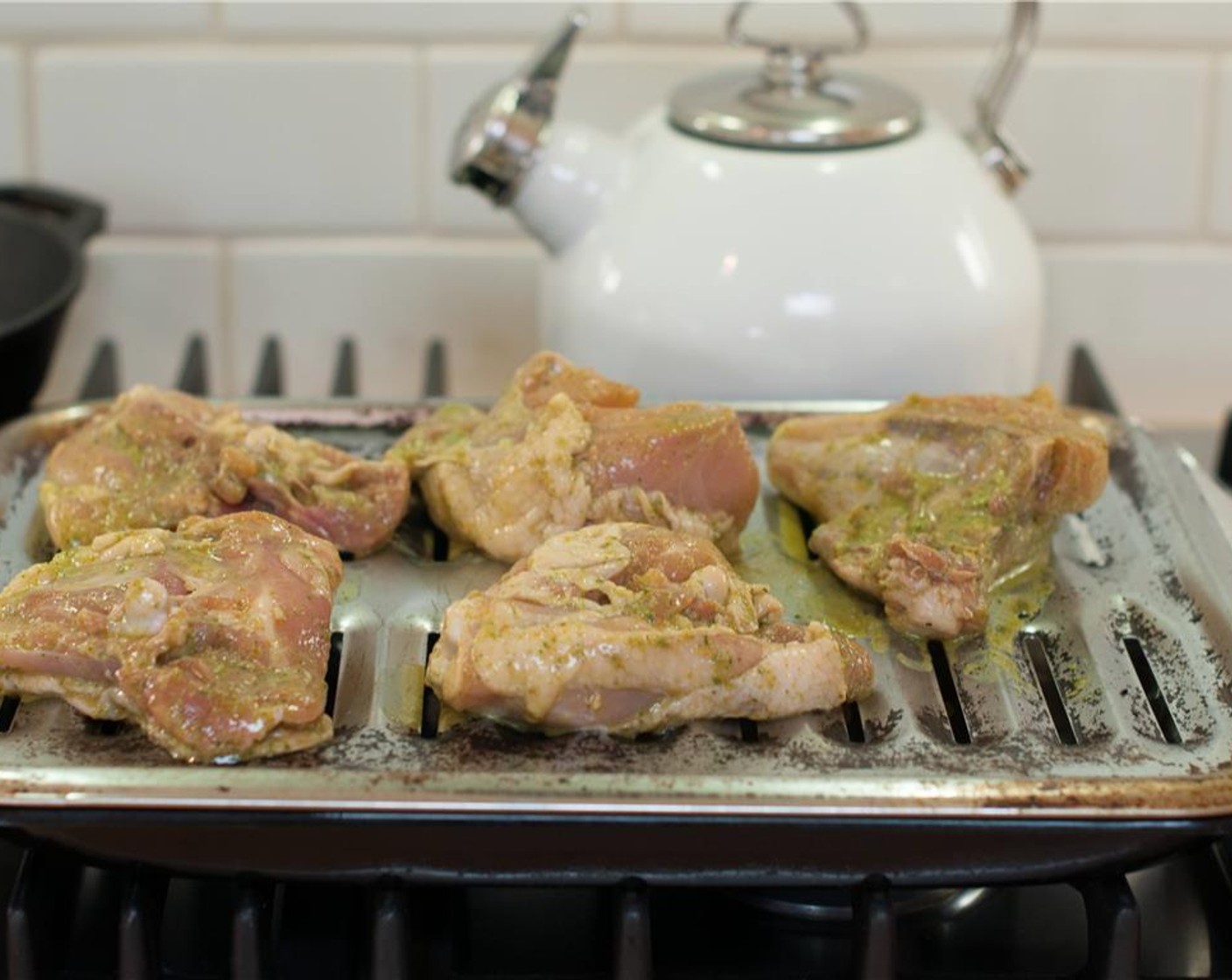 step 5 Place a broiling pan on top of a baking sheet. Remove the chicken from the marinade and place it skin side down on the pan, and place under the broiler and broil until lightly browned on the bottom, about 5 minutes.