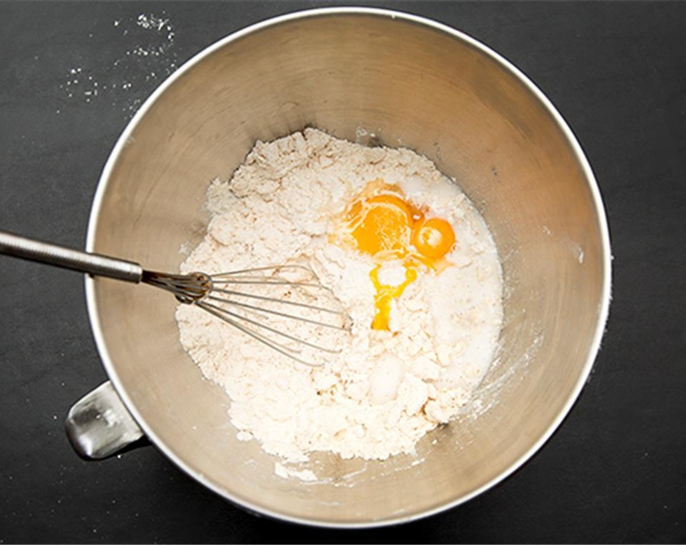 step 3 Whisk the Eggs (2) and Milk (4 Tbsp) together and add to dry mixture. When combined divide into two equal portions and wrap with plastic and chill for an hour.