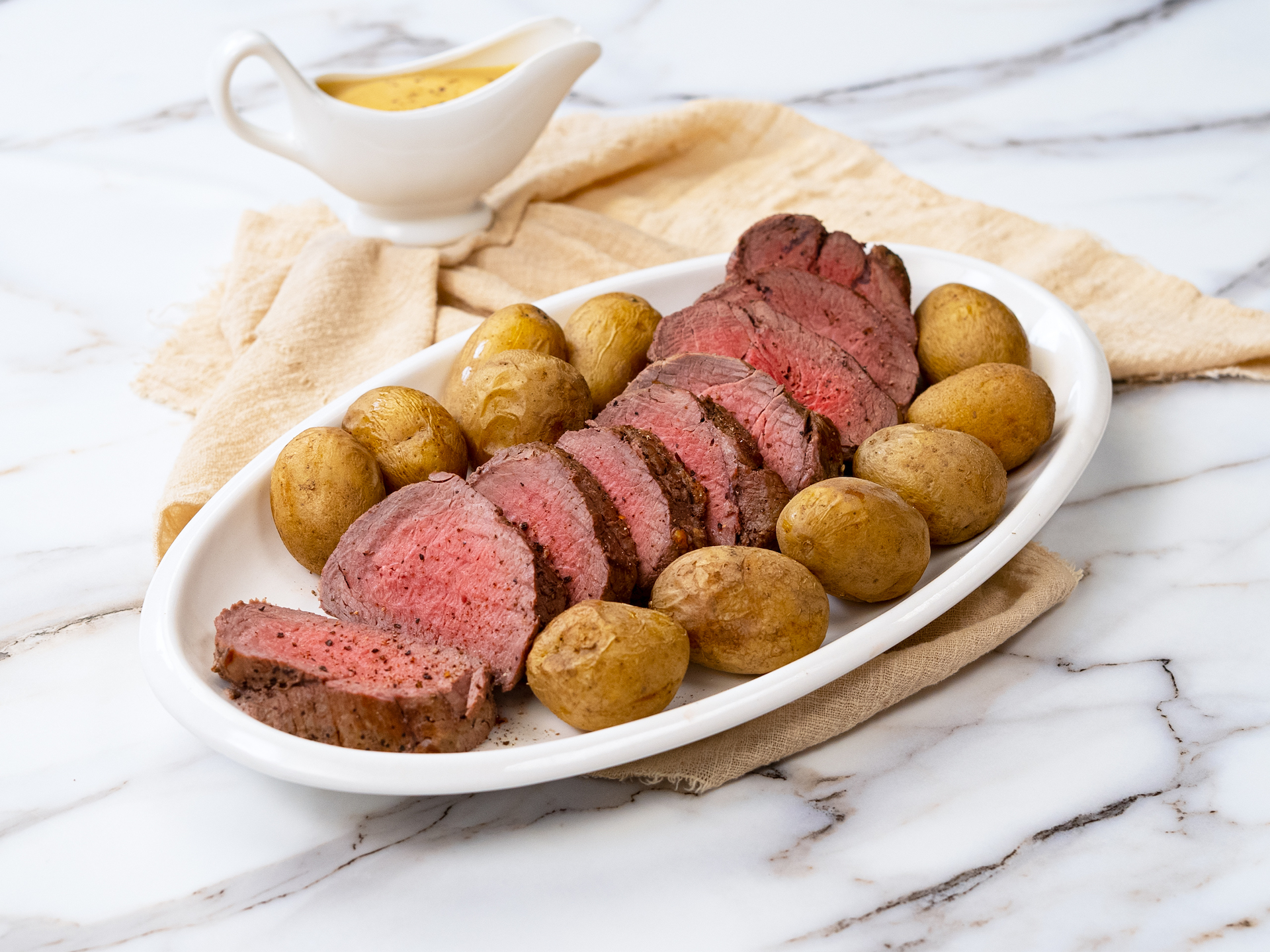 Sliced tender roast beef tenderloin with potatoes