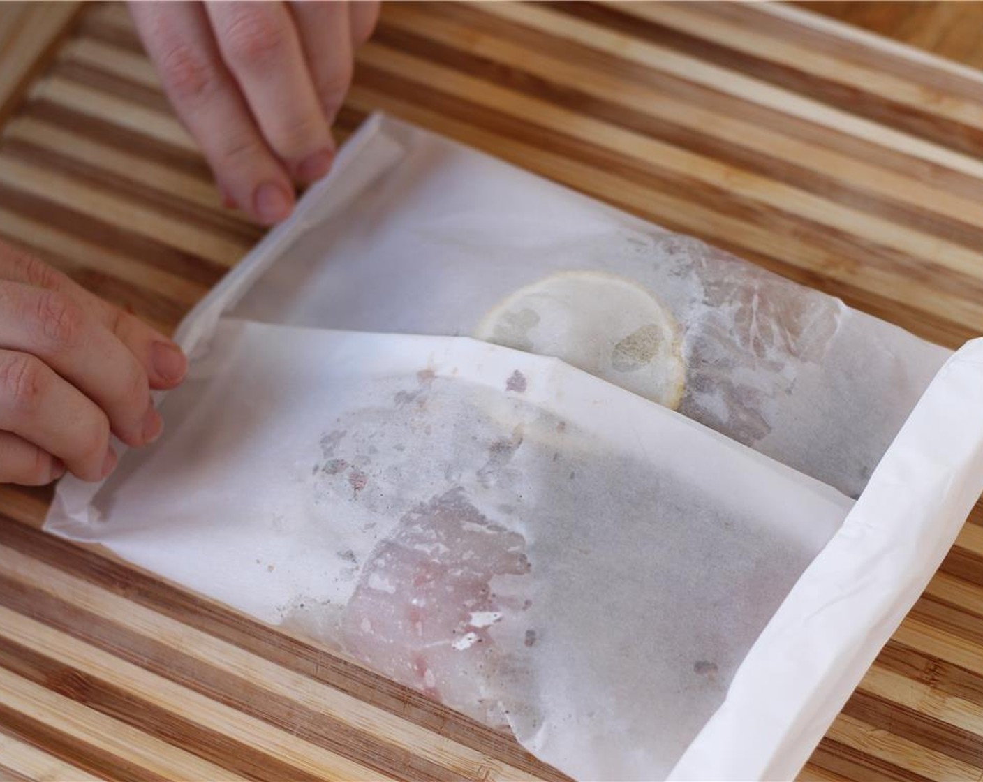 step 8 Then, seal both edges by folding tightly several times towards the center. Press down firmly on the seals.