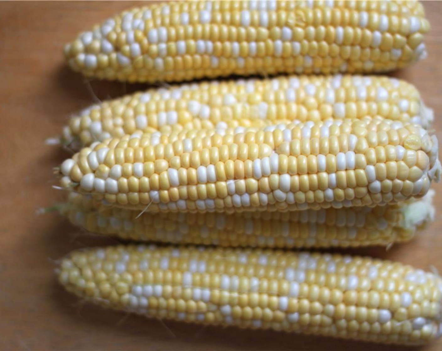 step 1 Heat a grill or grill pan to high heat. Husk and clean each ear of Corn (4 ears). Rub them with Olive Oil (1 Tbsp) and season with Salt (to taste) and Ground Black Pepper (to taste).