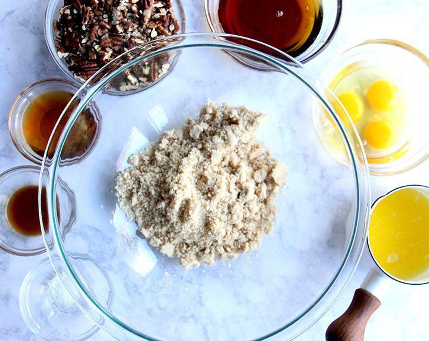 step 6 To make the filling, in a large bowl, whisk together the Dark Brown Sugar (1 cup), Maple Syrup (1/2 cup), Large Eggs (3), Butter (4 Tbsp), Bourbon (3 Tbsp), Vanilla Extract (1 tsp), and Salt (1/4 tsp). Stir in the Roasted Pecans (2 cups).