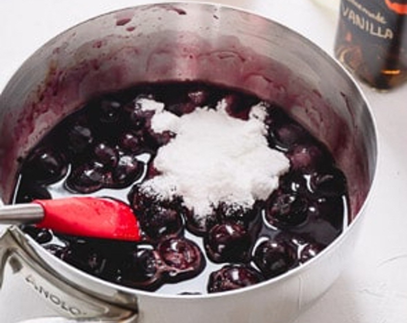 step 5 Add sugar mixture, Almond Extract (1/2 tsp), Vanilla Extract (1/2 tsp), and the juice from Lemon (1) to the boiling cherry. Mix well.