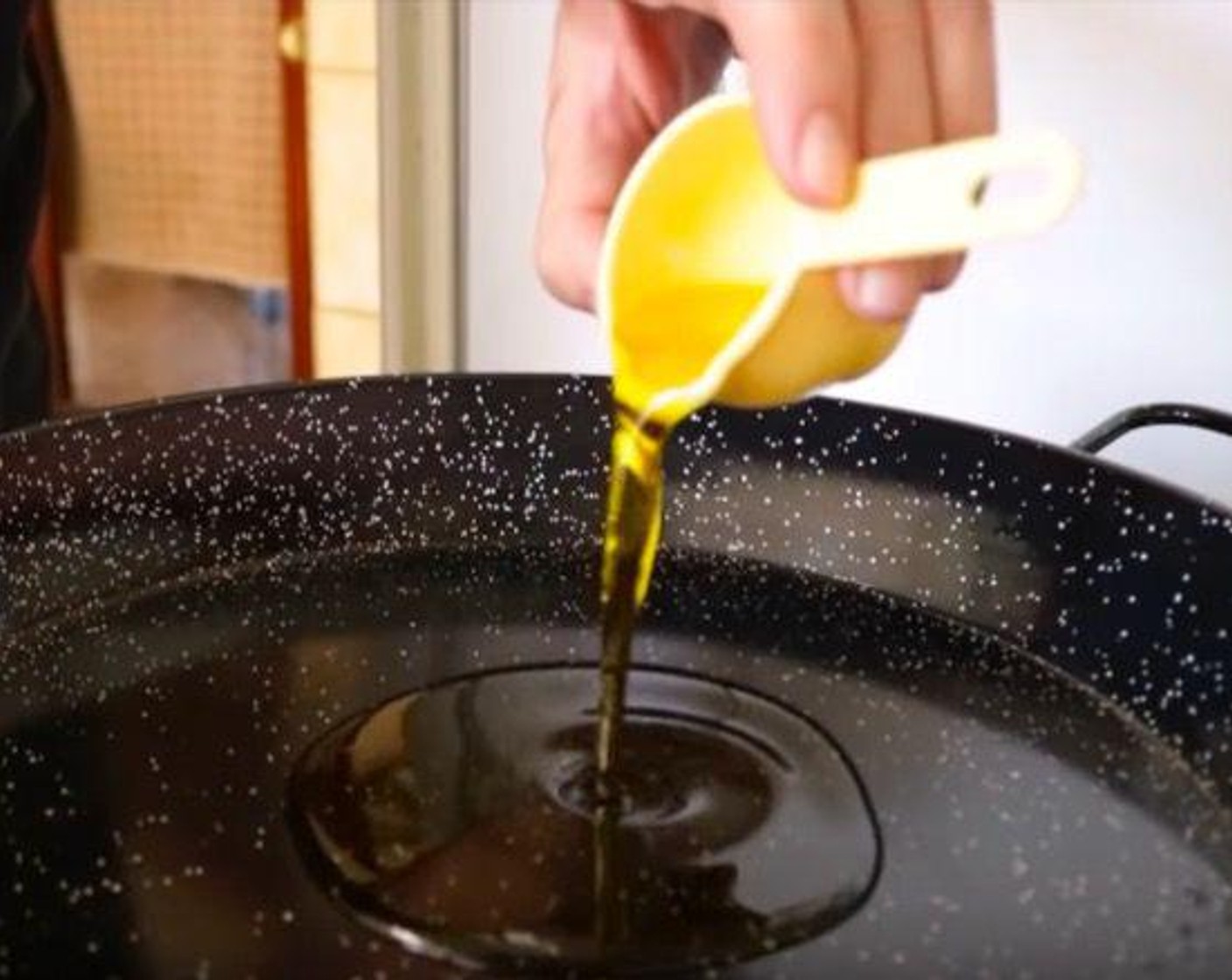 step 6 Heat a paella pan over a medium-high heat and add a Extra Virgin Spanish Olive Oil (4 Tbsp). Let warm up for 2 minutes.