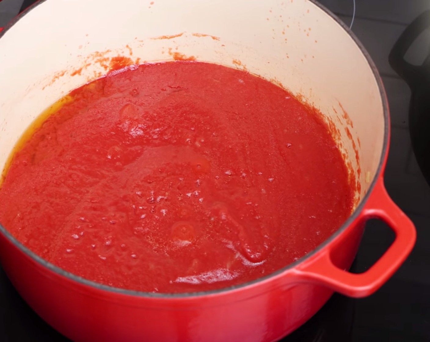 step 3 Now, add the Tomato Passata (2 bottles) and stir it really well so the onion combines with the sauce. Once it starts to simmer, add a pinch of Rock Salt (as needed).