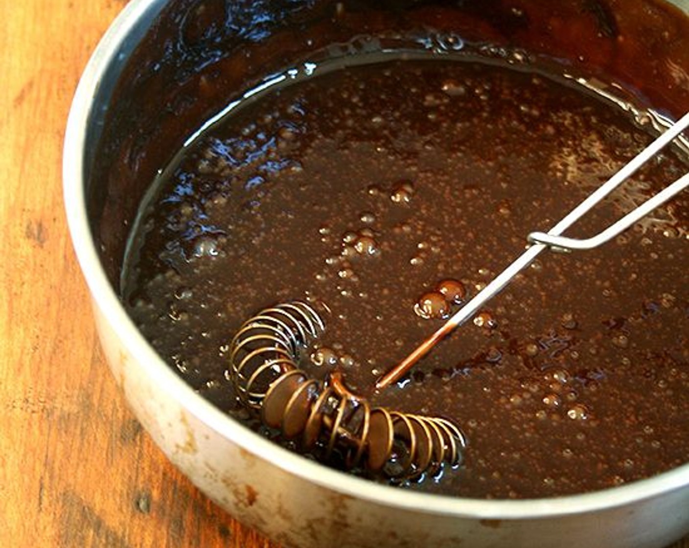 step 8 Meanwhile, make the icing: In a small saucepan over direct heat set on low, melt the Semi-Sweet Chocolate Chips (2/3 cup). Stir in the Powdered Confectioners Sugar (4 Tbsp). Stir in the Eggs (3), whisking constantly.