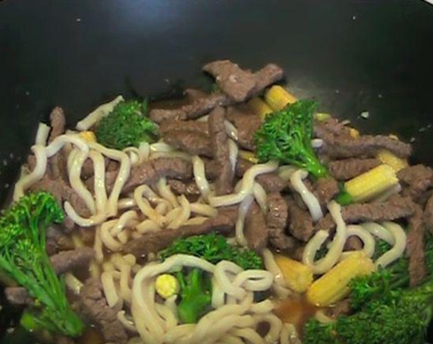 step 4 Return beef to the wok. Add Udon Noodles (7 oz) and the sauce. Cook for 3 minutes, or until the sauce has started to thicken.