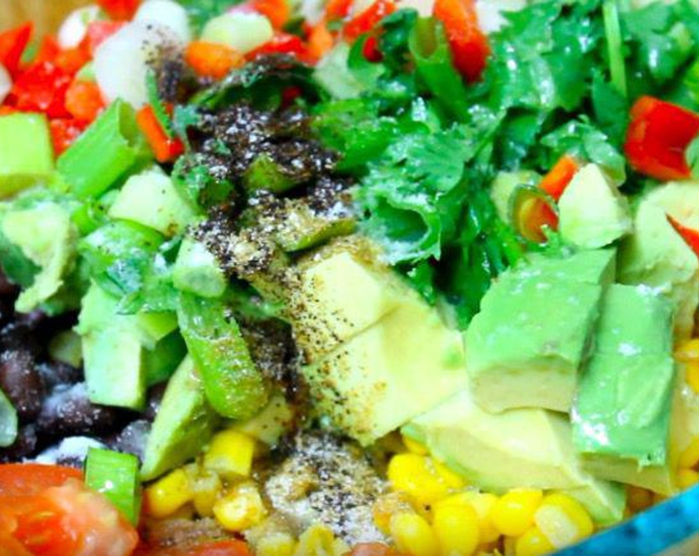step 1 In a mixing bowl, add Canned Black Beans (2 1/3 cups), Corn Kernels (2 1/2 cups), Plum Tomato (1), Avocado (1), Fresh Cilantro (4 Tbsp), Scallion (1 bunch), Red Bell Pepper (1), Ground Cumin (1/4 tsp), Chili Powder (1/2 tsp), Extra-Virgin Olive Oil (2 Tbsp), Salt (to taste), and Ground Black Pepper (to taste). Squeeze Lime (1) over top. Mix together.